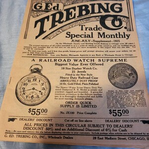 May include: A black and white advertisement for a railroad watch. The ad features a close-up of a gold pocket watch with Roman numeral markings. The text reads "A Railroad Watch Supreme" and "Biggest Value Ever Offered". The watch is described as "Heavy Duty Railroad Case, Absolutely Dust Proof, 10 Kt. Gold Filled, Plain Polished". The ad also includes the price of the watch, $55.00, and information about dealer discounts.