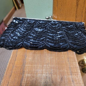 Vintage black loop beaded handbag with silver frame.   Beads move when carried.