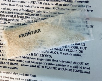 May include: A close-up of a white paper with instructions on how to make sourdough starter. The text includes the website address "https://www.zourdough.com/" and the email address "zourdoughstarter@live.com".