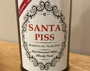May include: A brown glass bottle with a white label that says "Edizione Limitata" in red cursive. The label also features a black and white ornate frame with the text "SANTA PISS" in red letters. The text "Bottled in the North Pole" and "Best Consumed When Already Pissed" are also on the label.