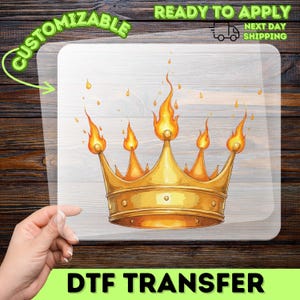 May include: A white ceramic mug with a black handle and the text "But First, Coffee" in a bold, black font. The mug is set against a blurred background, suggesting a cozy setting.