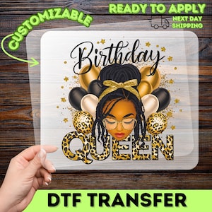 May include: A DTF transfer featuring a graphic of a Black woman with gold-rimmed glasses, a gold bow, and a leopard print design. The text "Birthday Queen" is displayed above the image, with "DTF TRANSFER" at the bottom. Gold and black balloons are in the background.
