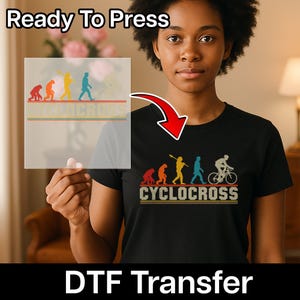 May include: Black t-shirt with a Cyclocross design featuring an evolution of man graphic. The design includes the text "CYCLOCROSS" in a vintage style. The words "Ready To Press" and "DTF Transfer" are also visible.