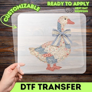 May include: A DTF transfer with a patchwork goose design. The goose has a red beak and feet, a blue and white gingham bow, and a body made of various fabric patterns. The words "Customizable" and "Ready to Apply" are visible.