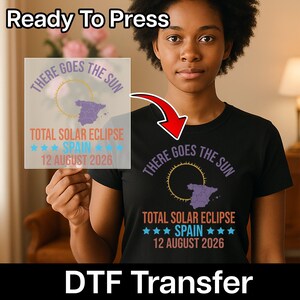 May include: Black t-shirt with a graphic design featuring the text "THERE GOES THE SUN" and "TOTAL SOLAR ECLIPSE SPAIN 12 AUGUST 2026". The image also shows a DTF transfer with the same design. The words "Ready To Press" and "DTF Transfer" are also visible.