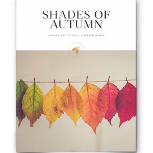 May include: A string of colorful autumn leaves hanging on a clothesline. The leaves range in color from green to yellow to orange to red. The text "Shades of Autumn" and "Lesson Fifty-One: Falling Down" is printed at the top of the image.