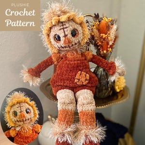 May include: A plushie scarecrow doll made of soft, textured yarn in shades of brown, tan, and orange. The doll features a stitched face, large dark eyes, and frayed yarn accents on the head, wrists, and ankles. Text reads Plushie Crochet Pattern.