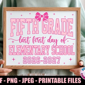May include: A rectangular wooden frame containing a white sign with pink text that reads FIFTH GRADE last first day of ELEMENTARY SCHOOL 2026-2027, featuring a pink bow graphic at the top and small pink star accents throughout the design.