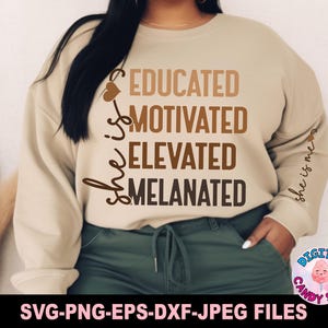 May include: A beige sweatshirt with the text "She is educated, motivated, elevated, melanated" printed in brown on the front. The text "She is me" is printed on the right sleeve in brown.