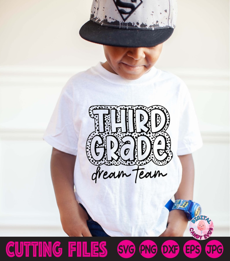 May include: A white t-shirt with black text that says "Third Grade Dream Team" in a bubble-like font with black polka dots.