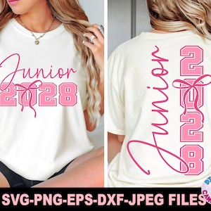 May include: A cream-colored t-shirt featuring pink graphic text that reads Junior 2028, accented with a pink bow illustration. The design appears on the front in a horizontal layout and on the back in a vertical layout with stacked numbers.