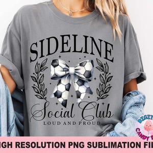 May include: Grey t-shirt with the text "Sideline Social Club Loud and Proud" and a black and white bow with a football design.