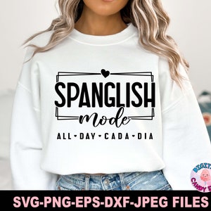 May include: White sweatshirt with black text that reads "SPANGLISH mode ALL DAY CADA DIA" with a small heart above the text.