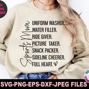 May include: Beige sweatshirt with black text that reads "Sports Mom" and a list of duties: "Uniform Washer, Water Filler, Ride Giver, Picture Taker, Snack Packer, Sideline Cheerer, Full Heart."