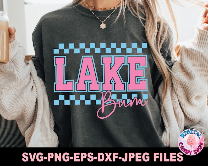 May include: Dark gray sweatshirt with the words "LAKE Bum" in pink and blue. The text is framed by a blue and white checkered pattern. The bottom of the image has the text "SVG-PNG-EPS-DXF-JPEG FILES".
