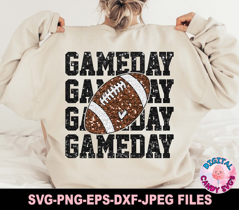 May include: A beige sweatshirt with the text "GAMEDAY" repeated four times in black glitter. A brown and white glitter football is centred on the sweatshirt.