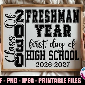 May include: A rectangular sign in a wooden frame featuring black text on a white background. The text reads Class of 2030, Freshman Year, first day of HIGH SCHOOL, and 2026-2027. The design uses a mix of bold block lettering and script fonts.