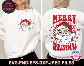 May include: White sweatshirt with a red and white "Merry Christmas" graphic featuring a cartoon Santa Claus with a winking eye. The graphic is surrounded by red and white checkered circles and snowflakes.