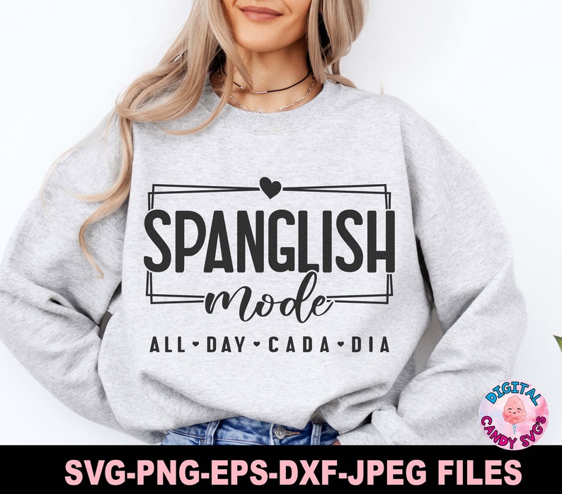 May include: A gray sweatshirt with the text "SPANGLISH mode ALL DAY CADA DIA" in black lettering with a heart above the word "SPANGLISH".