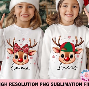 May include: Two white sweatshirts with reindeer graphics. One reindeer has a red bow, the other a green and red cap. The names "Emma" and "Lucas" are printed below the reindeer faces. The sweatshirts are for children.