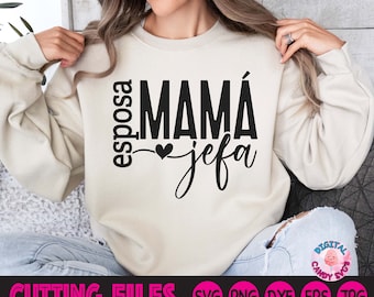 May include: A white sweatshirt with the text "esposa mamá jefa" in black lettering with a small heart between "mamá" and "jefa".