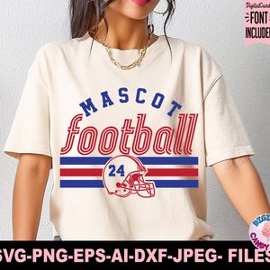 May include: Cream-colored t-shirt with the words "MASCOT football" in blue and red. Below the text is a red and blue striped design with a football helmet and the number 24. The shirt includes the text "FONT INCLUDED".