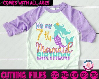 May include: White and purple raglan style t-shirt with a mermaid graphic. The shirt features the text "it's my 7th Mermaid Birthday" in teal, gold, and purple. The shirt is designed for a birthday celebration.