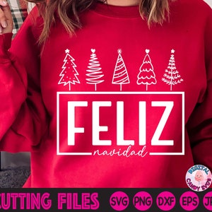 May include: A red sweatshirt with a white graphic featuring five Christmas trees and the words "FELIZ navidad" in a rectangular box. The bottom of the image displays "CUTTING FILES" and various file type abbreviations.