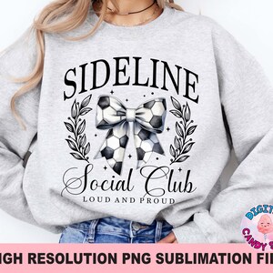 May include: Grey sweatshirt with the text "Sideline Social Club Loud and Proud" and a black and white football bow.