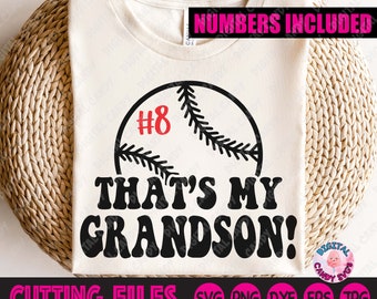 May include: A white t-shirt with a black baseball graphic and the text "That's My Grandson!" in black. The baseball has a red number 8 on it. The text "Numbers Included" is in pink at the top of the image.