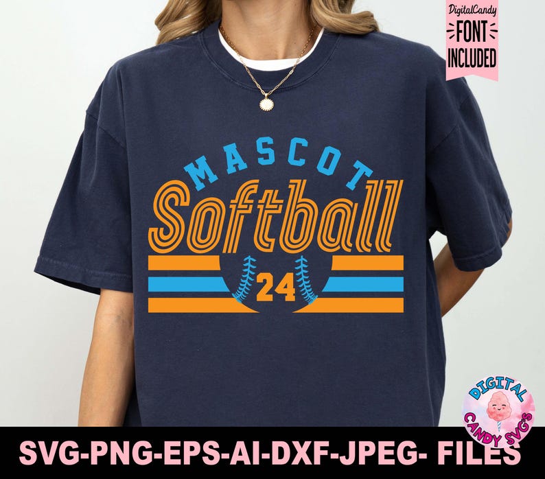 May include: A navy blue t-shirt with a graphic design of a softball with the text "MASCOT Softball 24" in orange and blue.