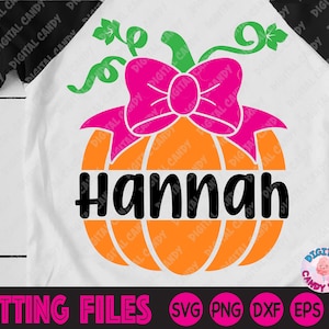 May include: A digital cut file design featuring a pumpkin with a pink bow and the name "Hannah" in black text. The pumpkin is orange with green vines and leaves. The design is perfect for creating personalized crafts and projects.