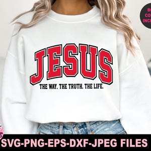 May include: White sweatshirt with the word "JESUS" in red block letters with a black outline. Below the word "JESUS" is the text "THE WAY. THE TRUTH. THE LIFE." The words "BOTH COLORS INCLUDED" are in a black circle.
