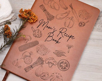 May include: A brown leather recipe book with the text "Mom's Recipe Book" and a design of various vegetables and fruits.