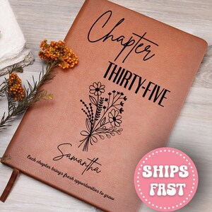 May include: A brown leather journal with the words "Chapter THIRTY-FIVE" in black script. A floral bouquet illustration and the name "Samantha" are below. The text "Each chapter brings fresh opportunities to grow" is at the bottom.
