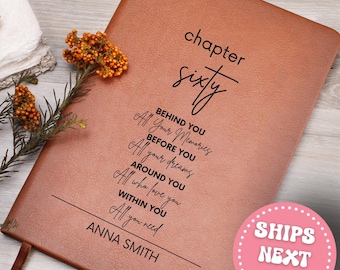 May include: A brown leather journal with the words "chapter sixty" and a list of inspirational phrases in black. The journal also includes the name "ANNA SMITH" at the bottom. A sprig of orange berries and greenery is on the left.
