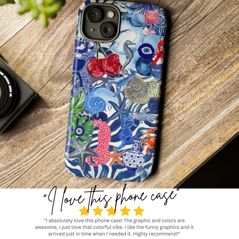 May include: A colourful phone case with a white background and a variety of blue, pink, and green illustrations. The illustrations include seashells, seahorses, fish, cherries, and an evil eye. The case has the text "Greer" on it.