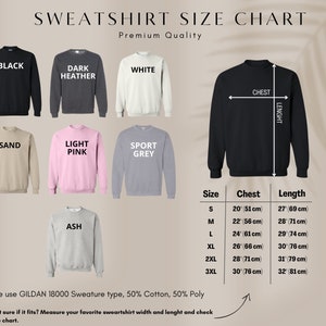 May include: Sweatshirt size chart showing chest and length measurements in cm and inches. Sizes range from S to 3XL. Colors include black, dark heather, white, sand, light pink, sport grey, and ash. The chart uses GILDAN 18000 material.