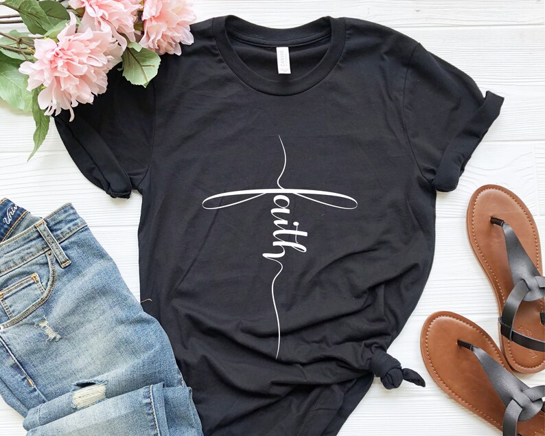 May include: Black t-shirt with a white cross and the word "faith" written inside the cross.