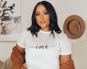 May include: A white t-shirt with the word "oma" written in cursive on the front.