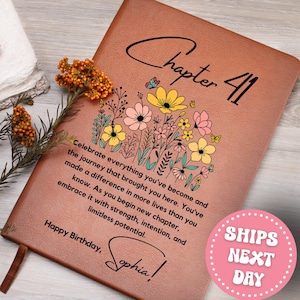 May include: A brown leather journal with the words "Chapter 41" and a floral design. The journal includes the text "Celebrate everything you've become" and "Happy Birthday, Sophia!"