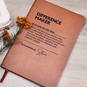May include: A brown leather journal with the words "Difference Maker" and a definition of the term. The journal also includes the text "Also known as: Steve".