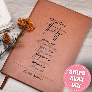 May include: A brown leather journal with the words "chapter thirty" and inspirational text. The journal includes the name "ANNA SMITH" at the bottom. A sprig of orange berries and a white cloth are in the background.