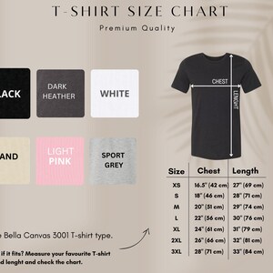 May include: T-shirt size chart with chest and length measurements in cm and inches. Includes color swatches for black, dark heather, white, sand, light pink, and sport grey. The chart shows sizes XS to 3XL.