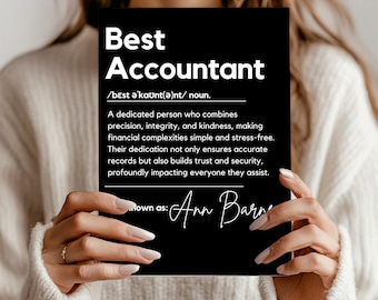 May include: A black rectangular sign with the words "Best Accountant" in white. The sign includes a definition and the name "Ann Barne" in cursive. The sign is held by a person.