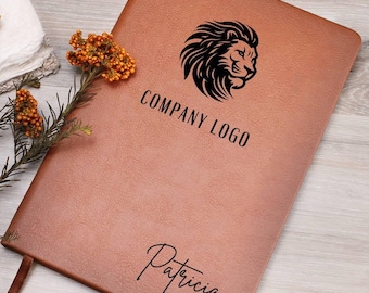 May include: A brown leather-bound journal with a black lion logo and the text "COMPANY LOGO". The name "Patricia" is written in cursive below the logo.