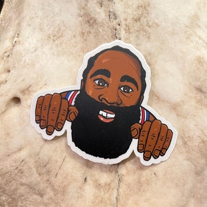 May include: A sticker of a cartoon basketball player with a beard, wearing a red, white, and blue jersey. The player is smiling and has his hands up, as if he is reaching out.