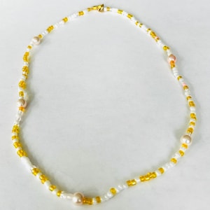 Beaded yellow and white necklace with light pink pearls