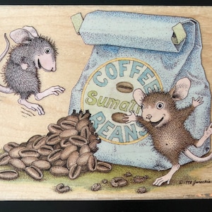 May include: Two mice are standing near a bag of coffee beans. The bag is blue and white with the words "Coffee Sumatran Beans" printed on it. The mice are brown and gray with big ears and tails. There are coffee beans scattered on the ground.