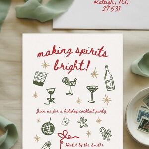 May include: A white invitation card with red and green text that reads "making spirits bright!" and includes illustrations of cocktails, a disco ball, a gingerbread man, and a candy cane. The text also includes the details of a holiday cocktail party hosted by the Smiths on December 21st at 6 PM at 25 Holly Lane, Raleigh, NC. RSVP to Ally at 123-456-7890.